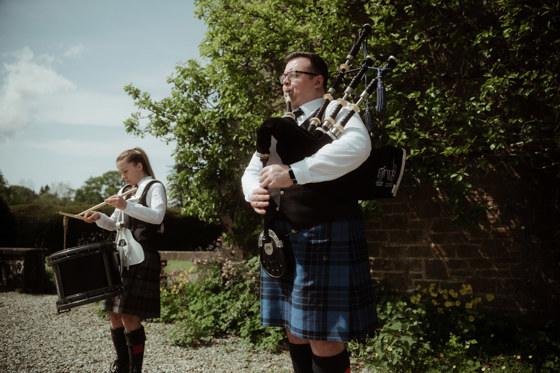 Bagpipe player and drummer in kilts organised by White Heather Wedding & Event Planning Services